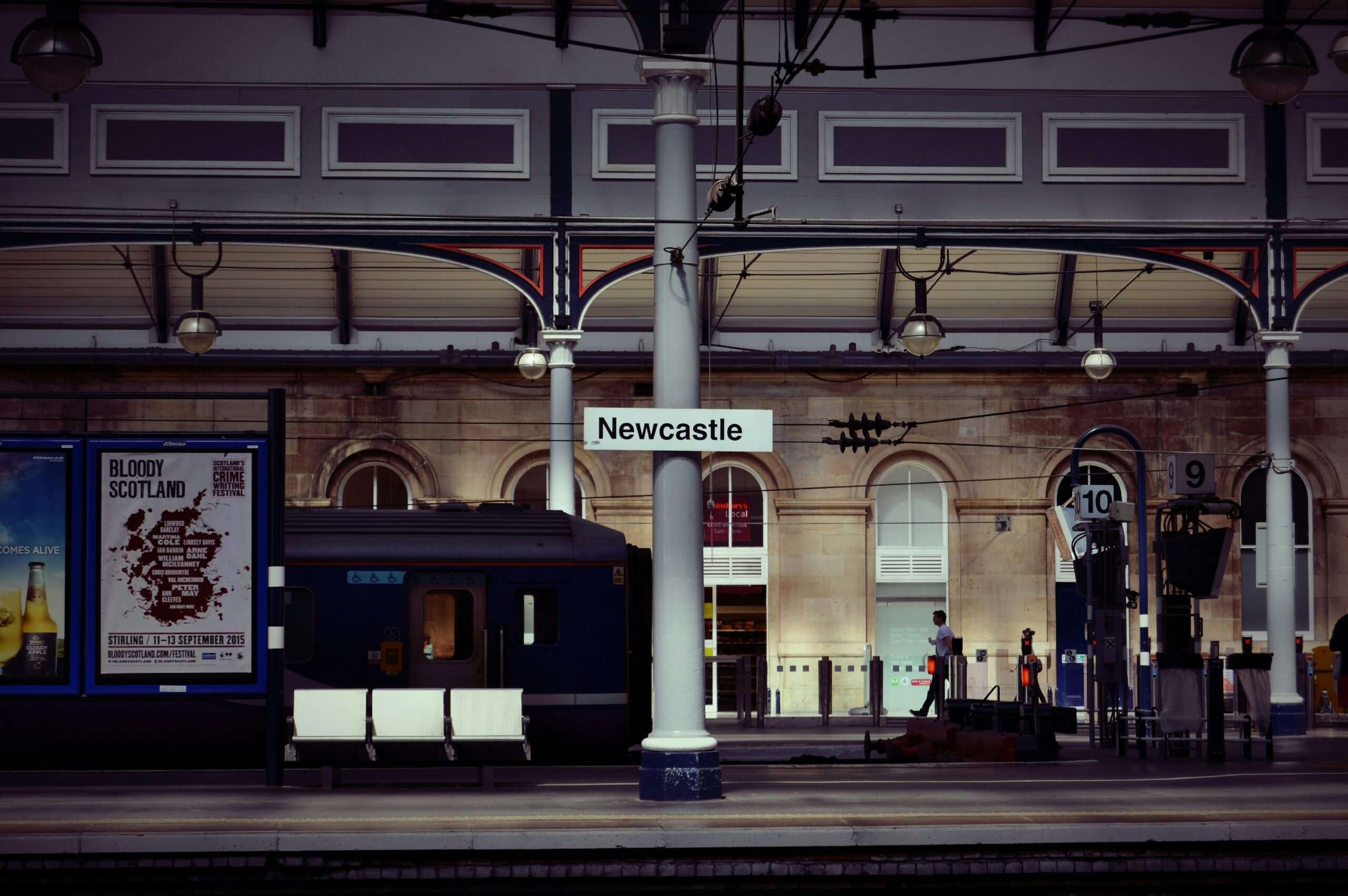 train platform with newcastle sign