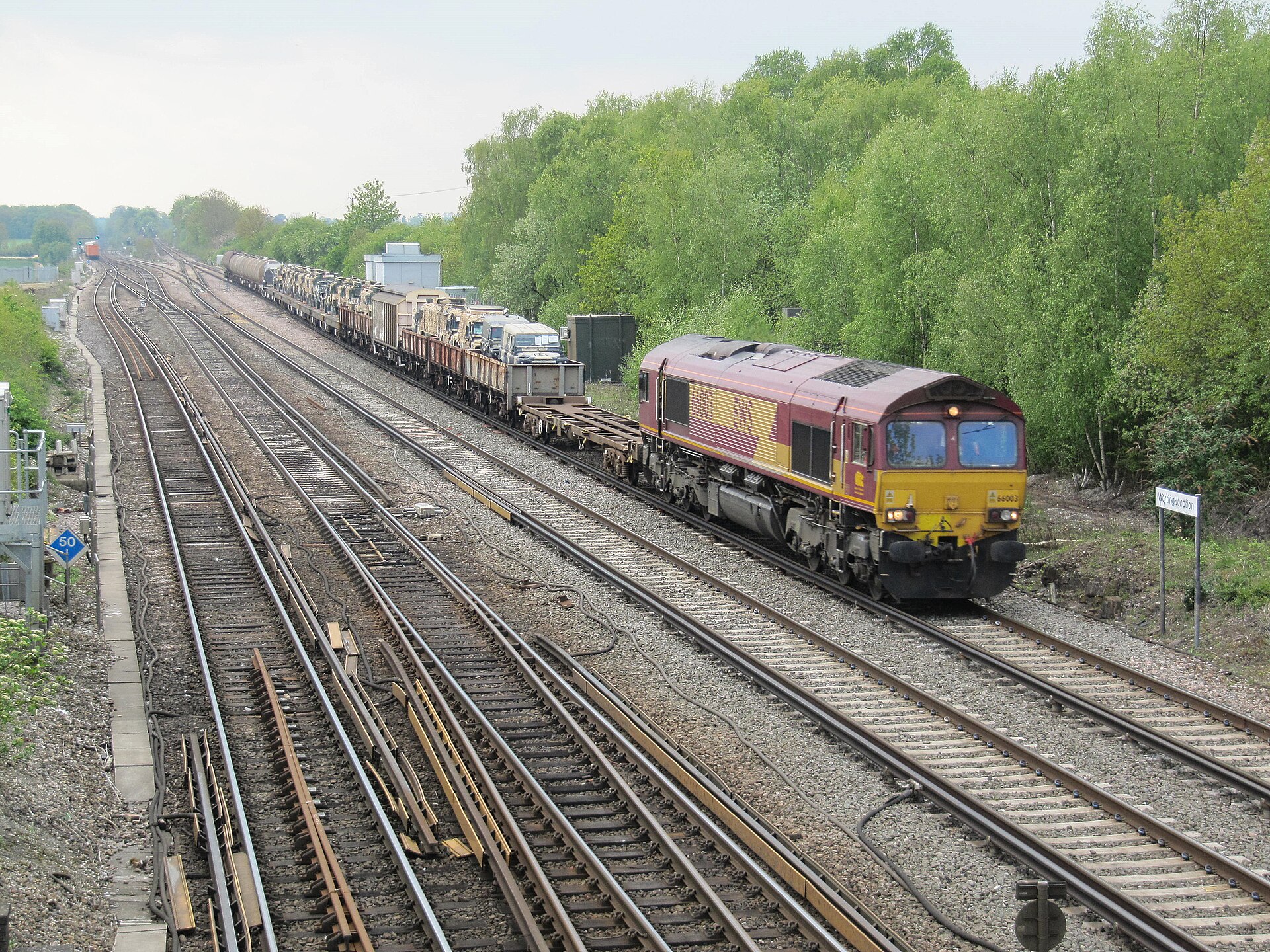 Class 66 locomotive hauling a freight train past Worting Junction, near Basingstoke